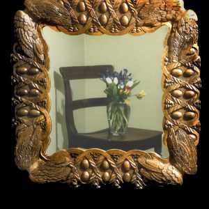 Frame based on a design of pheasant wings and eggs. Carved in pearwood and then wax polished